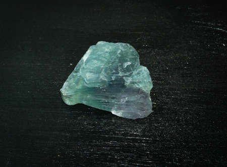 Fluorite fluorspar from Brazil. Natural mineral stone on a black background. Mineralogy, geology, magic of stones, semi-precious stones and samples of minerals. Close-up macro photo.の写真素材