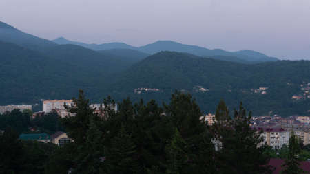 LAZAREVSKOE, SOCHI, RUSSIA - MAY, 27, 2021: Panorama of sunset in the mountains. A magical view of the sea and small town from the observation deckのeditorial素材