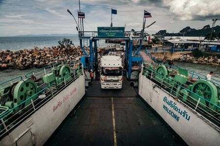 Vehicle being loaded on ferry to leave for island in Thailand.のeditorial素材