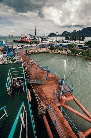 View from above of dock and moored ferry ready to leave to island, Thailand.のeditorial素材