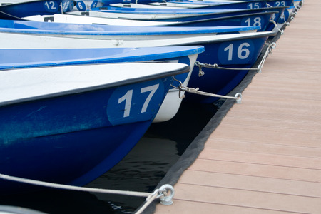 The boats on the boat parking fastened by the rope compositionの写真素材