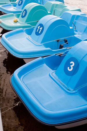 The boats on the boat parking fastened by the rope compositionの写真素材