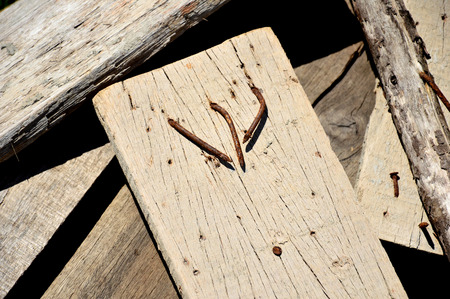 Old nails on old wood put on stack of woods.の写真素材