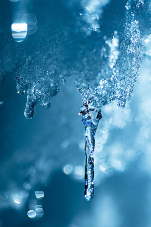 Icicle on a blue background. Macro photo with shallow depth of fieldの写真素材