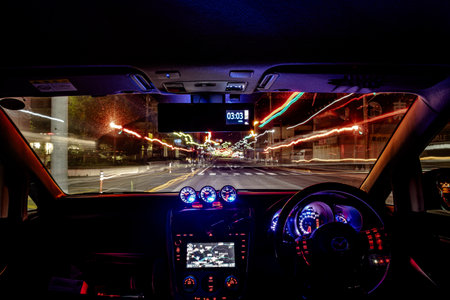 Interior view of a modern car in the city at night.のeditorial素材