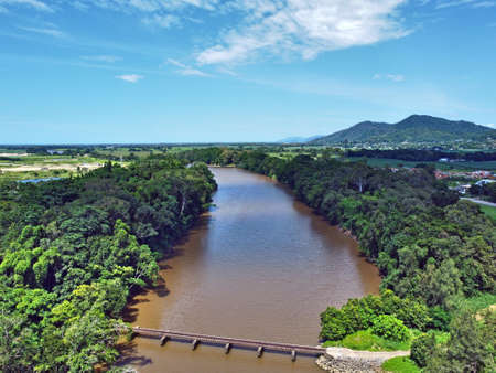 Aerial view of train bridge of brown riverの写真素材