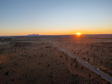 A breathtaking aerial view of a desert landscape illuminated by a stunning sunsetの写真素材