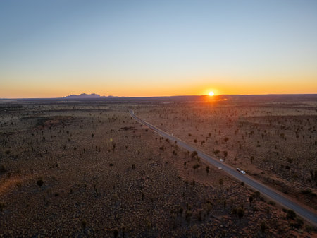 A breathtaking aerial view of a desert landscape illuminated by a stunning sunsetの写真素材