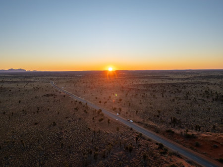 A breathtaking aerial view of a desert landscape in Australia illuminated by a stunning sunsetの写真素材