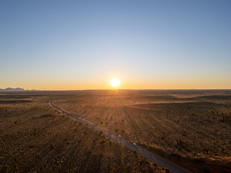 A breathtaking aerial view of a desert landscape in Australia illuminated by a stunning sunset