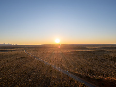 A breathtaking aerial view of a desert landscape in Australia illuminated by a stunning sunsetの写真素材