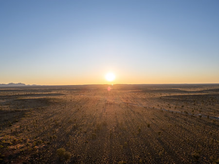 A breathtaking aerial view of a desert landscape in Australia illuminated by a stunning sunsetの写真素材