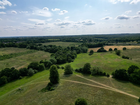 Aerial view of park and woodland showing fields, housing estates and natureの写真素材