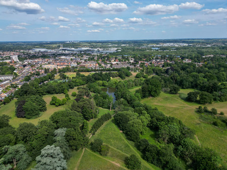 Aerial view of park and woodland showing fields, housing estates and natureの写真素材