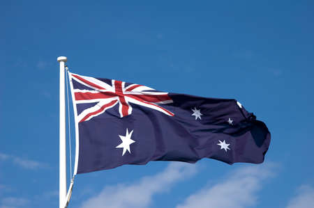 Australian flag against a blue sky backgroundの写真素材