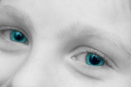 closeup view of a young boy with brilliant blue eyesの写真素材