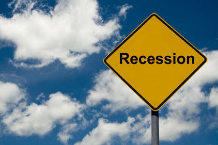 Recession road sign against a blue sky backgroundの写真素材