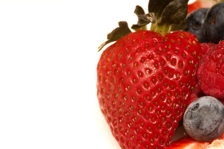 closeup view of delicious raspberries and blueberries and strawberries isolated on a white backgroundの写真素材