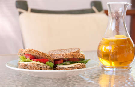 light summer fare with whole wheat sesame sandwiches and iced tea with lemonの写真素材