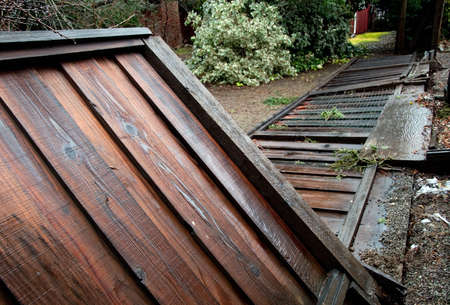 a fence downed by heavy rain and stormの写真素材