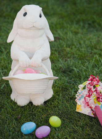 white rabbit on lawn with easter eggsの写真素材