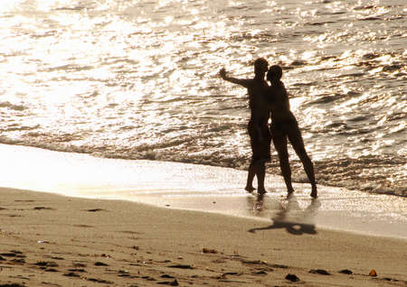 a couple taking their own photograph in la jollaの写真素材
