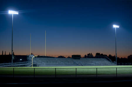 two stadium lights sparkle in the nightの写真素材