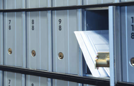 mail waiting in the u.s. grey/blue post office boxの写真素材
