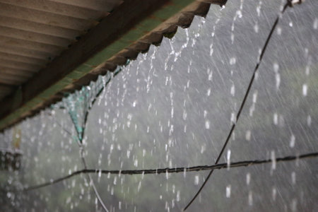 Raindrops dripping from the roof in a sudden downpour