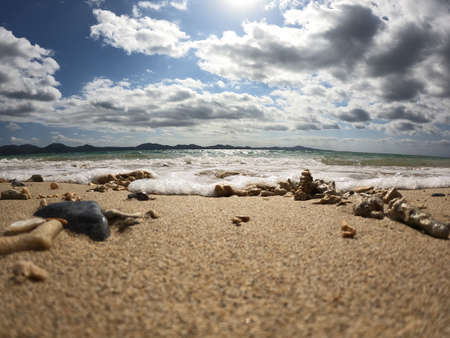 The sandy beaches of the southern country where bubbling waves are approachingの写真素材