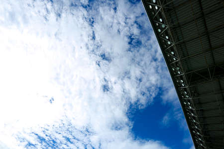 Looking up at the sky from a soccer stadium in the middle of summerの写真素材