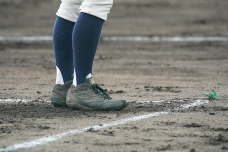 A coach calls out to his players to inspire them during a baseball game.の写真素材
