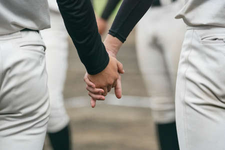 Baseball players form a circle at a baseball game to unify their spirit.の写真素材