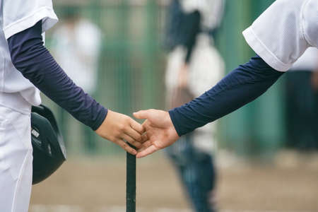 Baseball players form a circle at a baseball game to unify their spirit.の写真素材