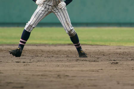 Baseball player attempting to steal a base during a baseball game.の写真素材