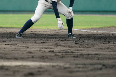 Baseball player attempting to steal a base during a baseball game.の写真素材