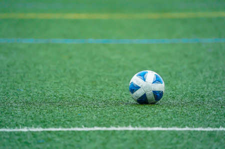 Soccer ball lying on artificial turf pitch of soccer field (bright version)の写真素材