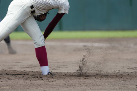 Mound where the pitcher throws a pitch and dirt rises up during a baseball game.の写真素材