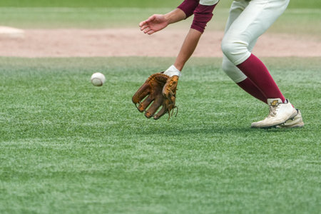 Second infielder catching a batted ball during a baseball game.の写真素材