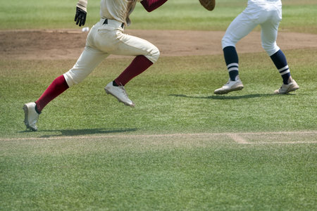 First base runner dashing to second base during a baseball gameの写真素材