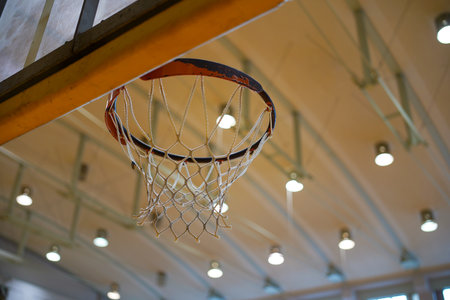 Rusty old basketball goal in gymnasiumの写真素材
