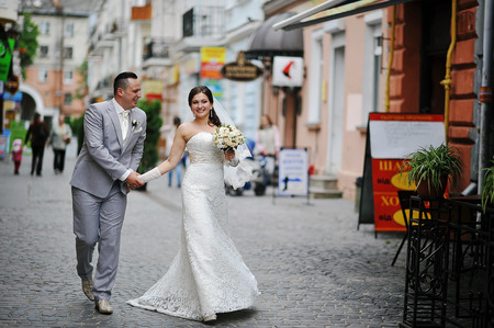 Just married wedding couple walking at the streets of townの写真素材
