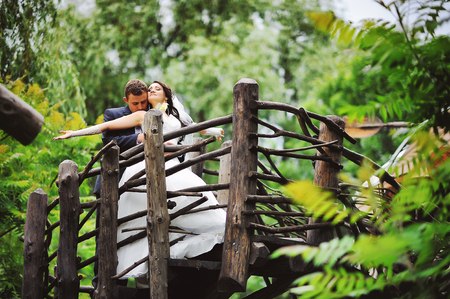 wedding couple on the wooden stairsの写真素材