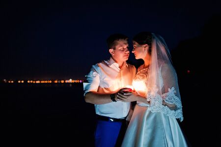 happy marriage at night with candlesの写真素材