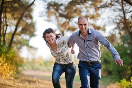 Happy and positive couple in autumn love storyの写真素材