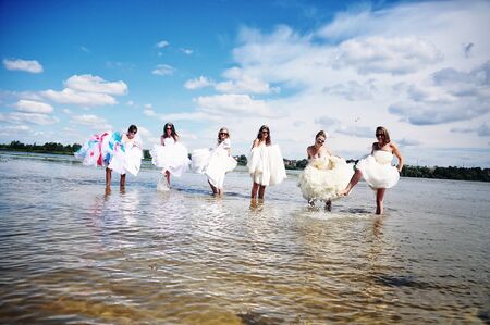 brides having fun on the waterの写真素材