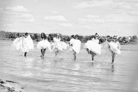 brides having fun on the beachの写真素材