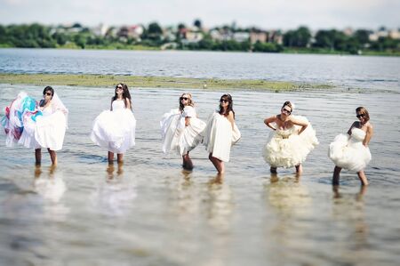 brides having fun on the beachの写真素材