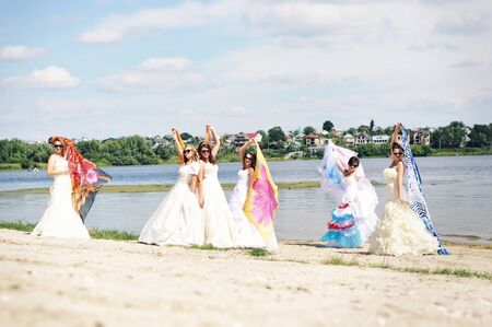 brides having fun on the beachの写真素材