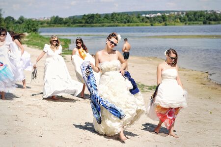 brides having fun on the beachの写真素材